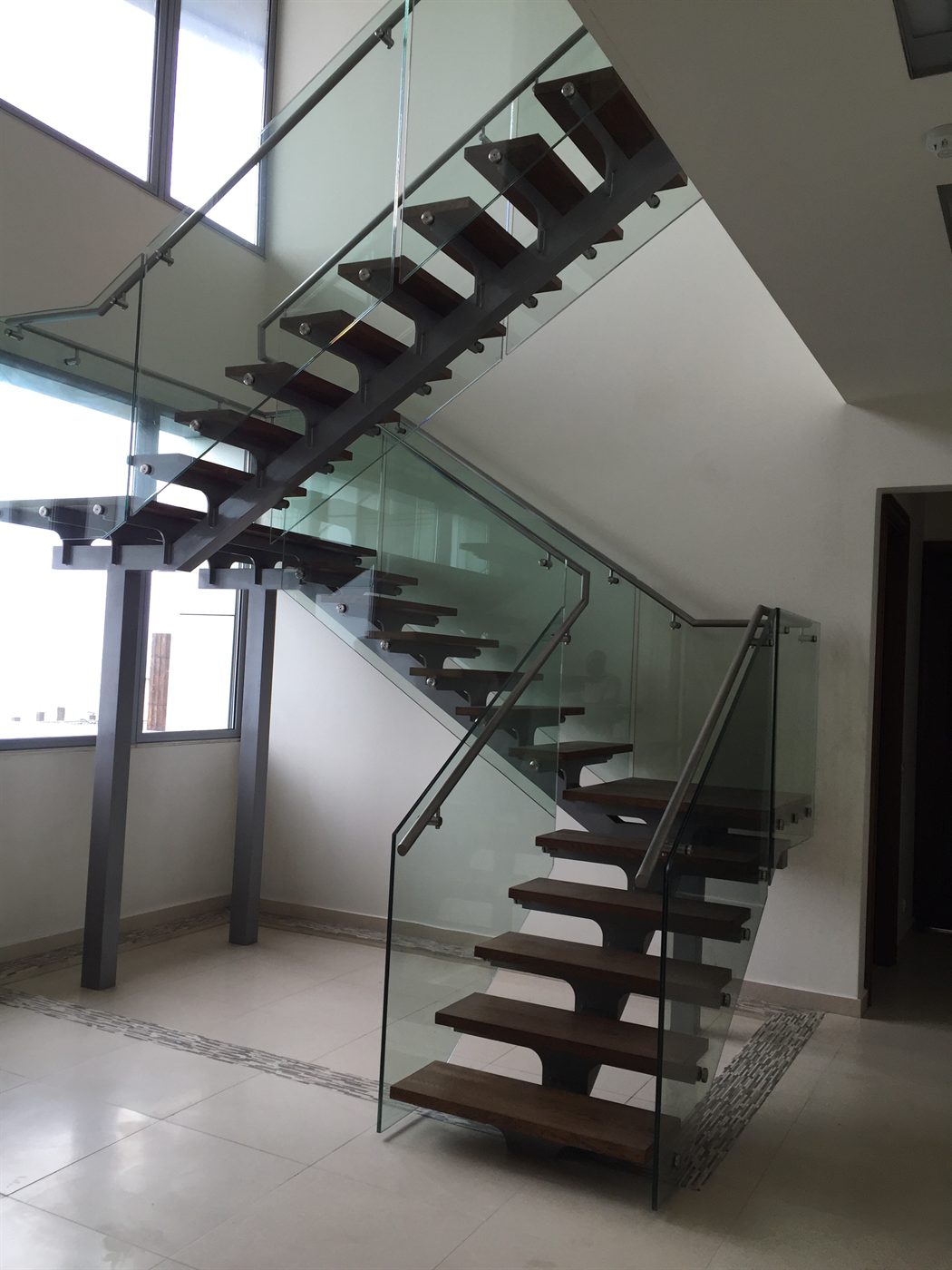 Steel stringer staircase with timber treads and a glass balustrade