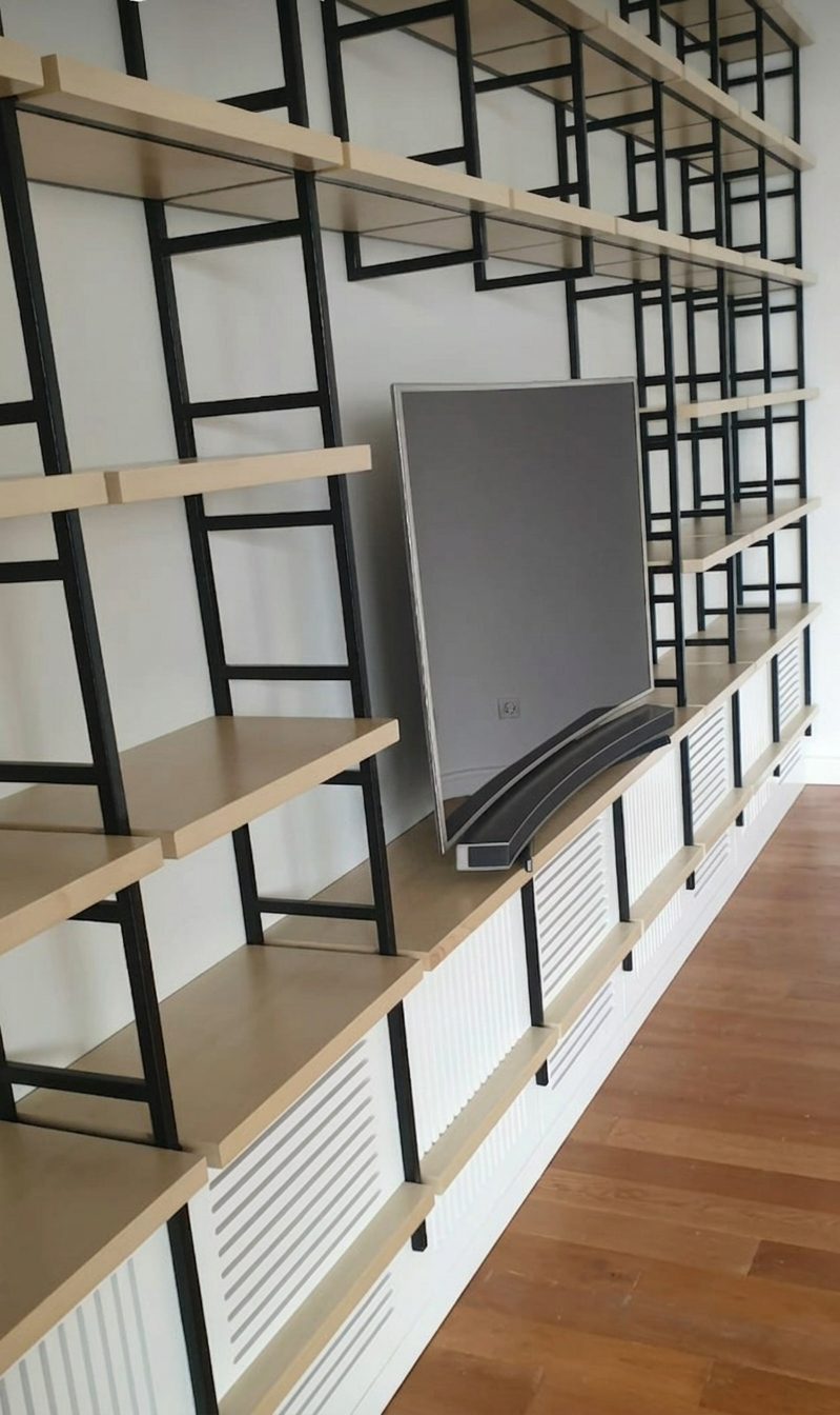 Steel and timber shelving unit over a slatted radiator cover