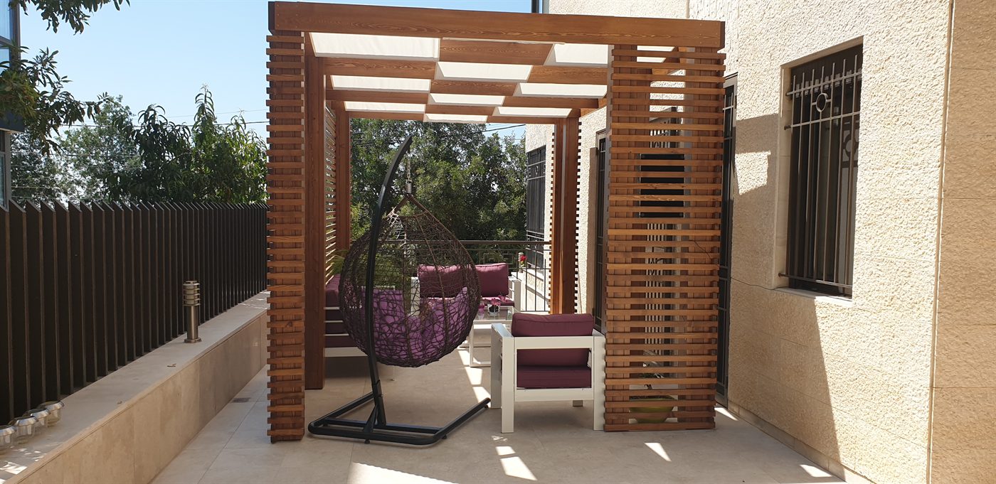 Slatted timber pergola over a garden terrace