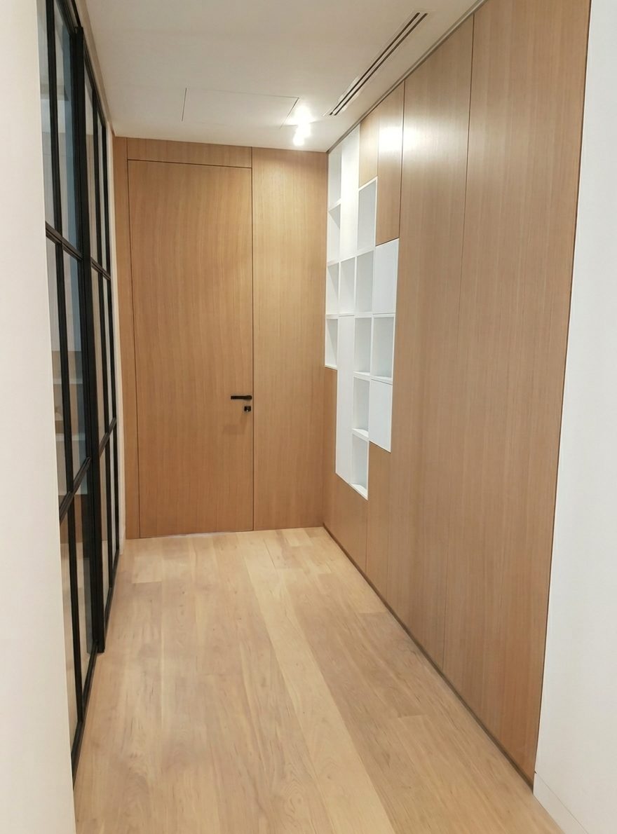 Corridor lined in oak panelling with recessed display niches