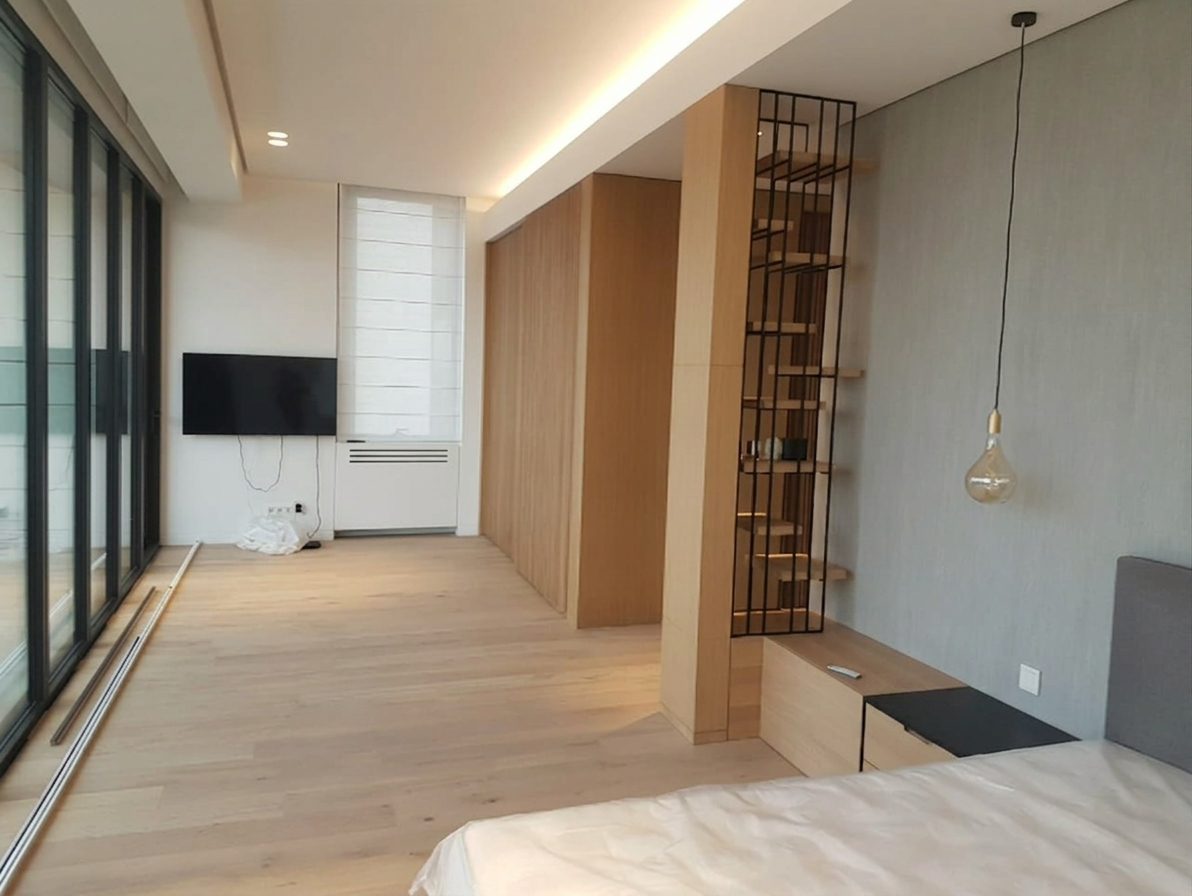 Master bedroom with a slatted oak screen and full-height glazing