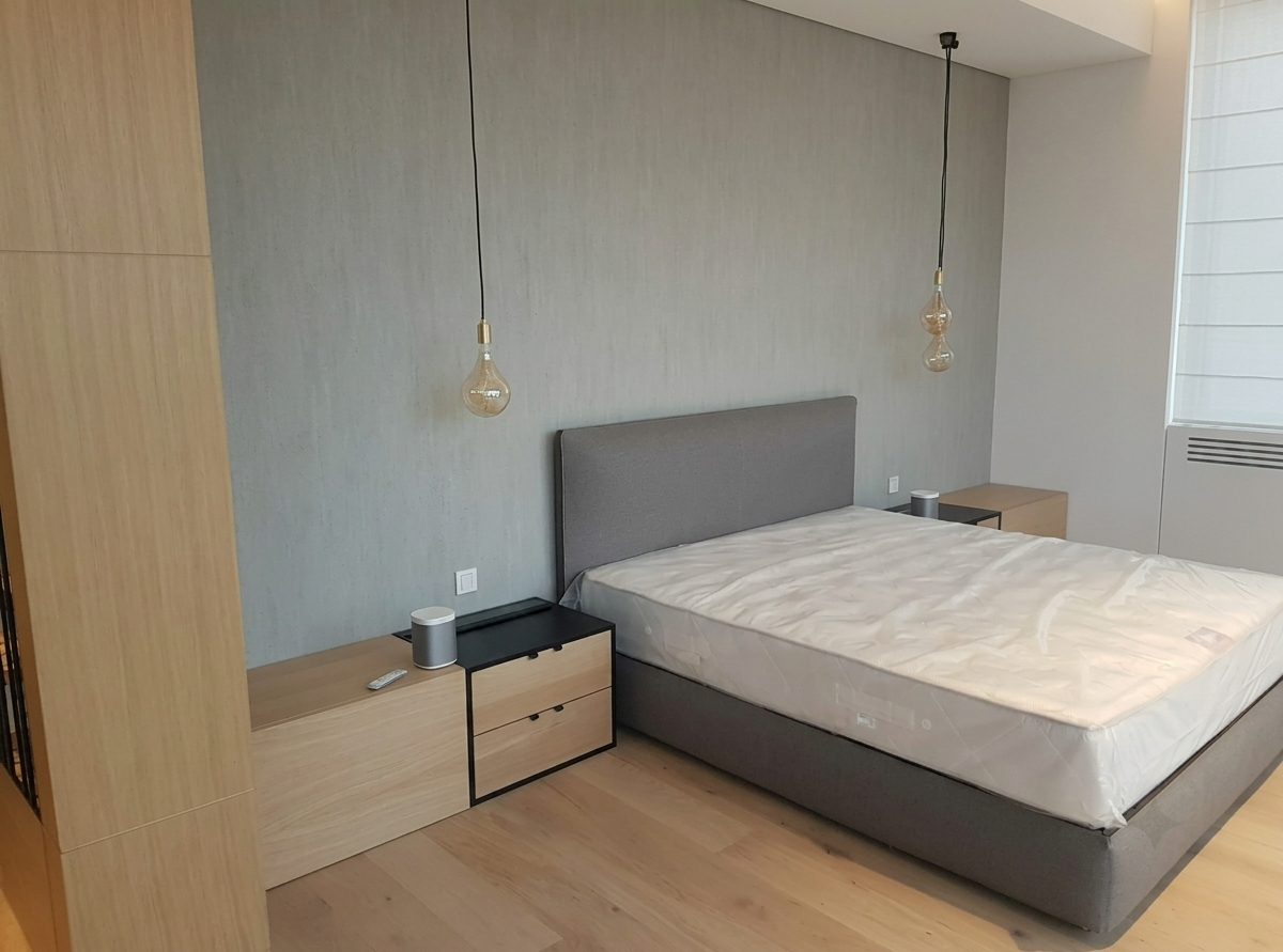 Master bed with an upholstered headboard and fitted bedside units
