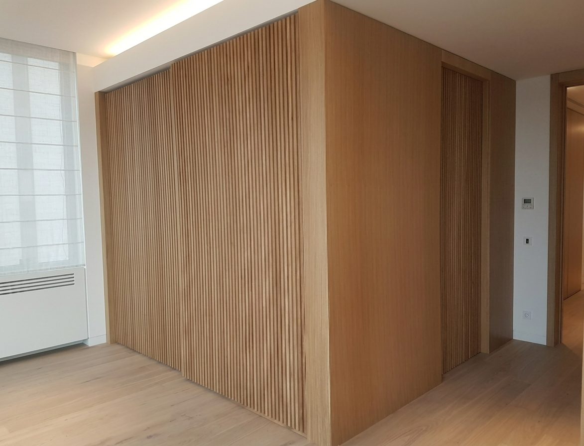 Fluted oak wardrobe wall in the master suite