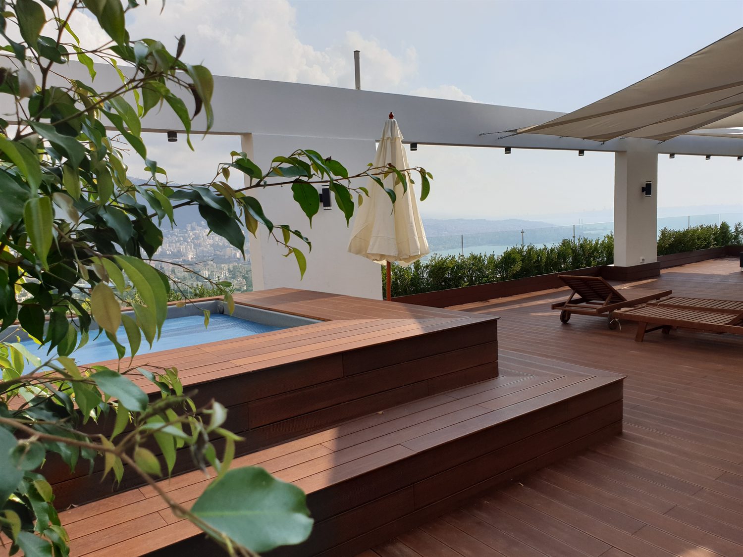 Pool and stepped deck by day, looking out over the valley