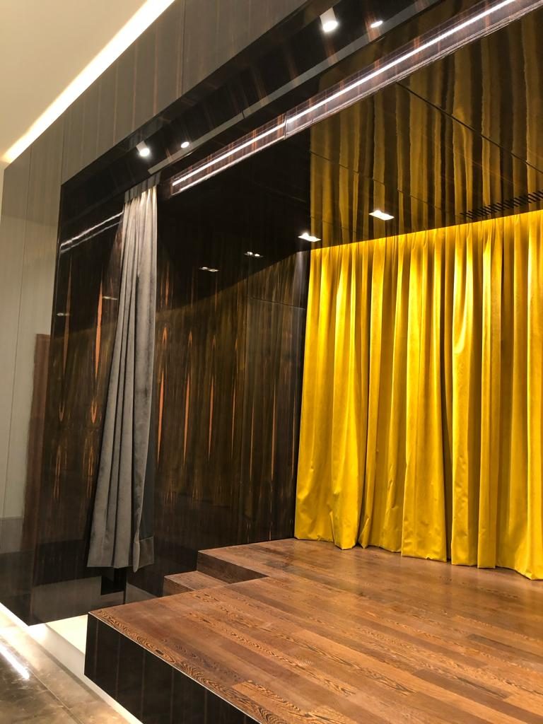 Timber stage steps against high-gloss dark panelling