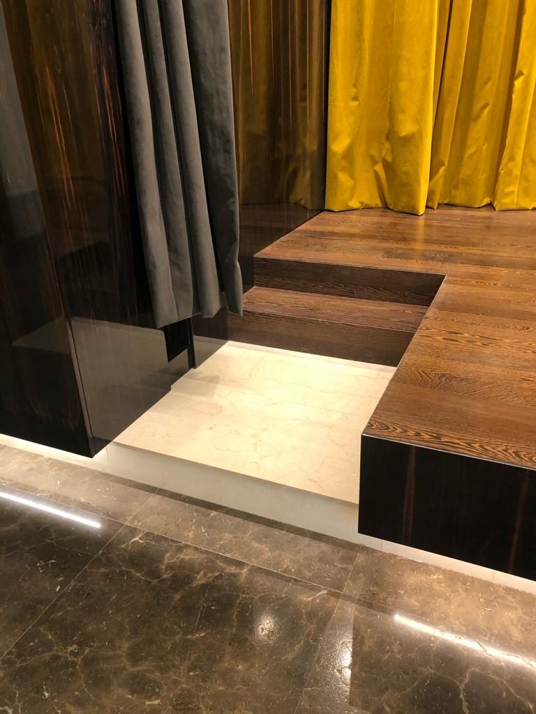 Marble steps meeting the timber stage edge