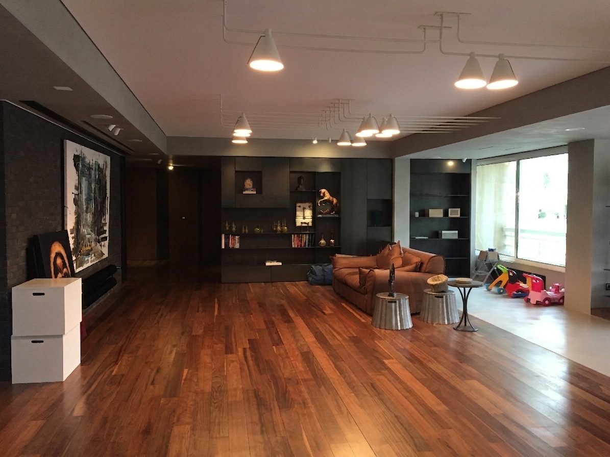 Open living room with a hardwood floor and pendant lighting