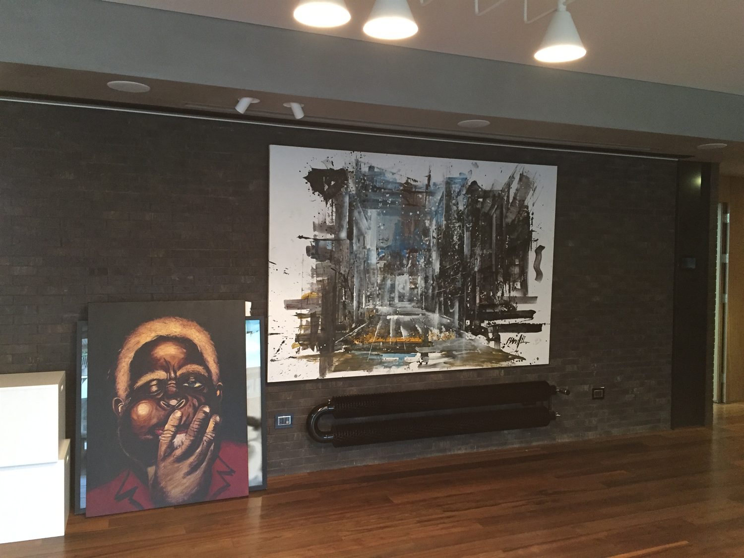 Living room art wall in dark brick with a radiator cover below