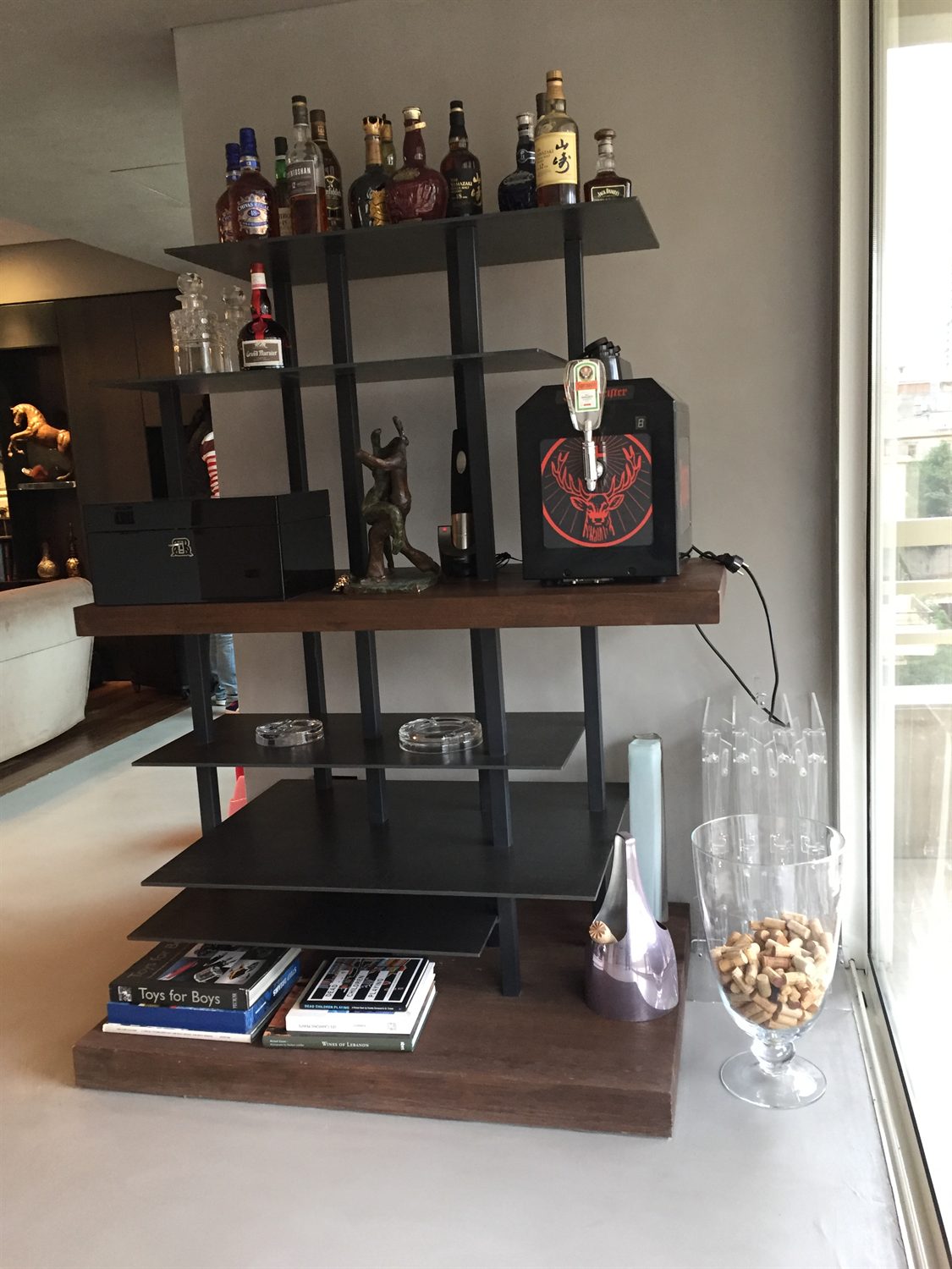 Bar with blackened steel shelving over a timber counter