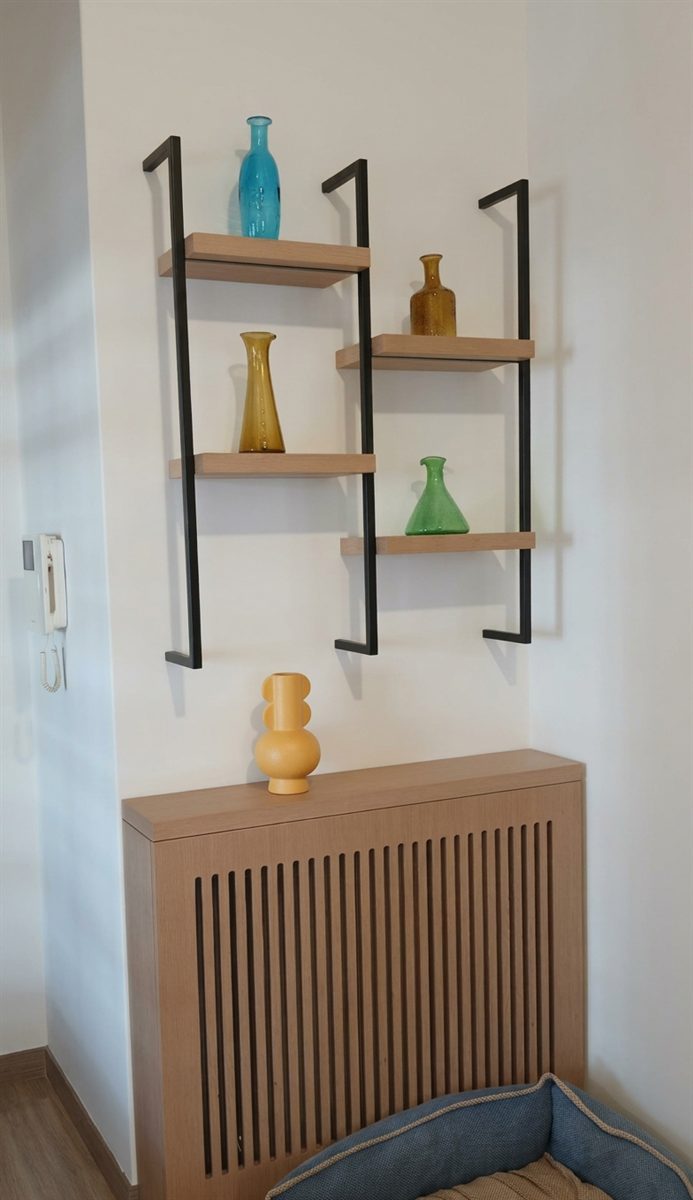 Bespoke wall shelving above a slatted timber radiator cover